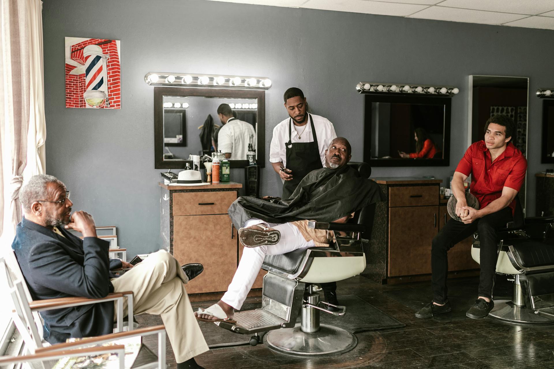 Four men hanging out inside the barbershop