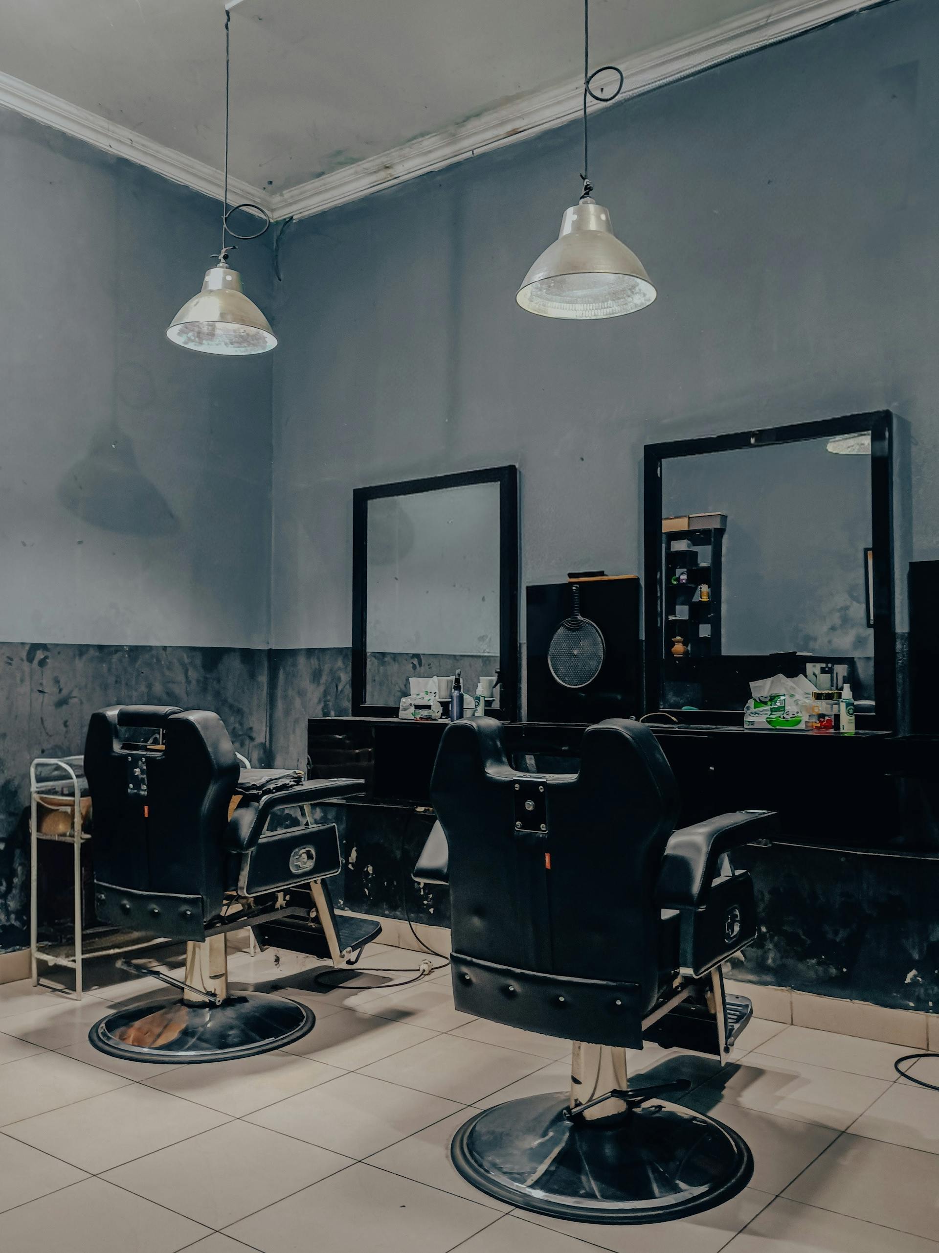 Barbershop interior with two chairs and hanging lamps