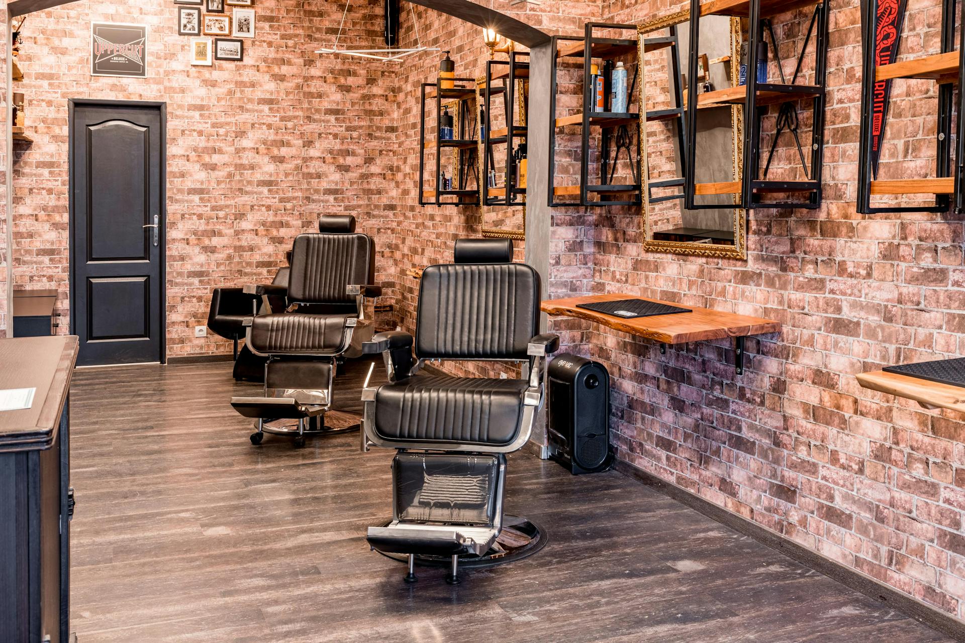 Industrial Brooklyn barbershop interior with exposed brick walls and black leather chairs
